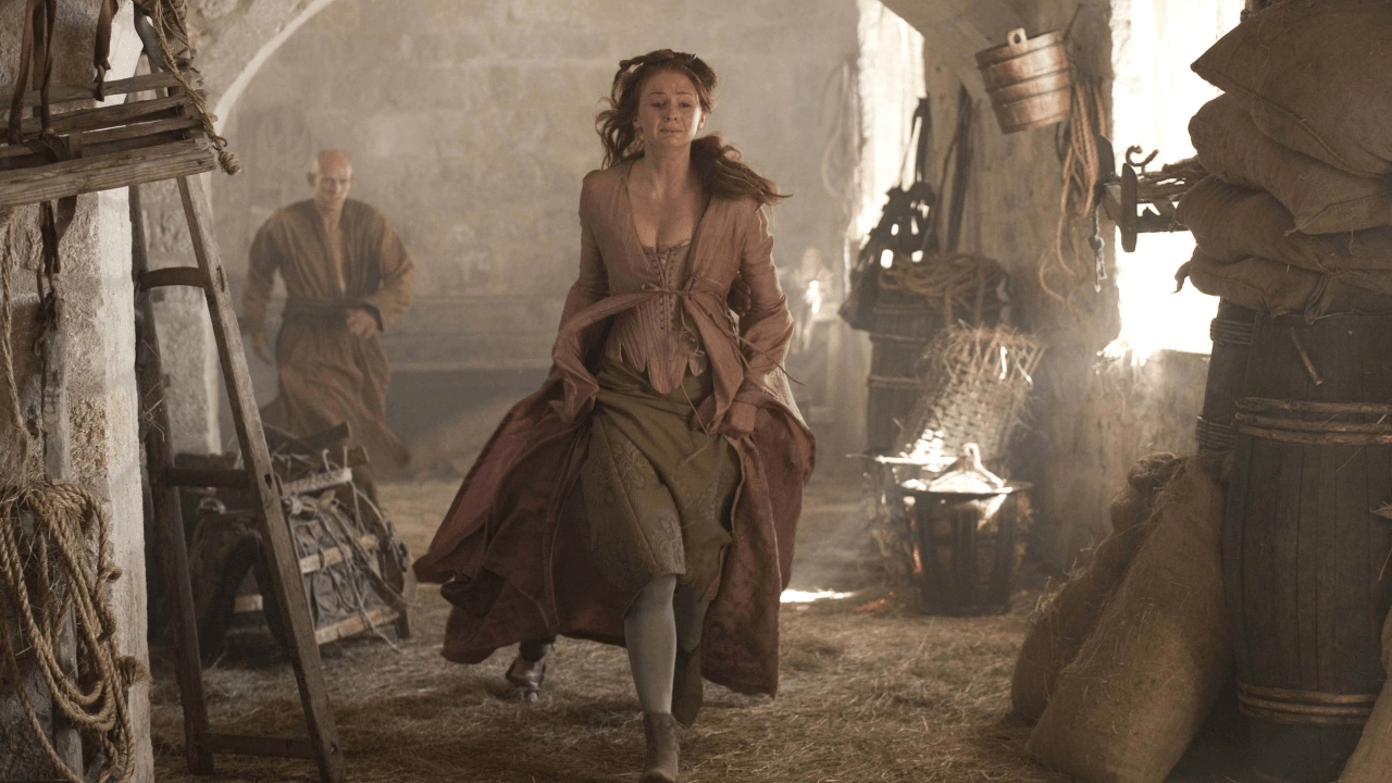 Game of Thrones S2E6 "The Old Gods and the New" episode guide featured image showing a lone armored figure in a castle courtyard as smoke rises in the distance