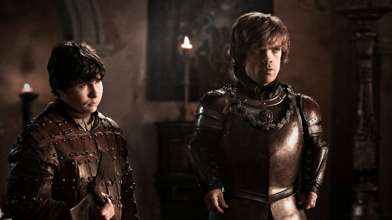 A nighttime siege of a city gate with ships burning on the river and the Game of Thrones S2E9 "Blackwater" episode guide focus on the battlefield chaos