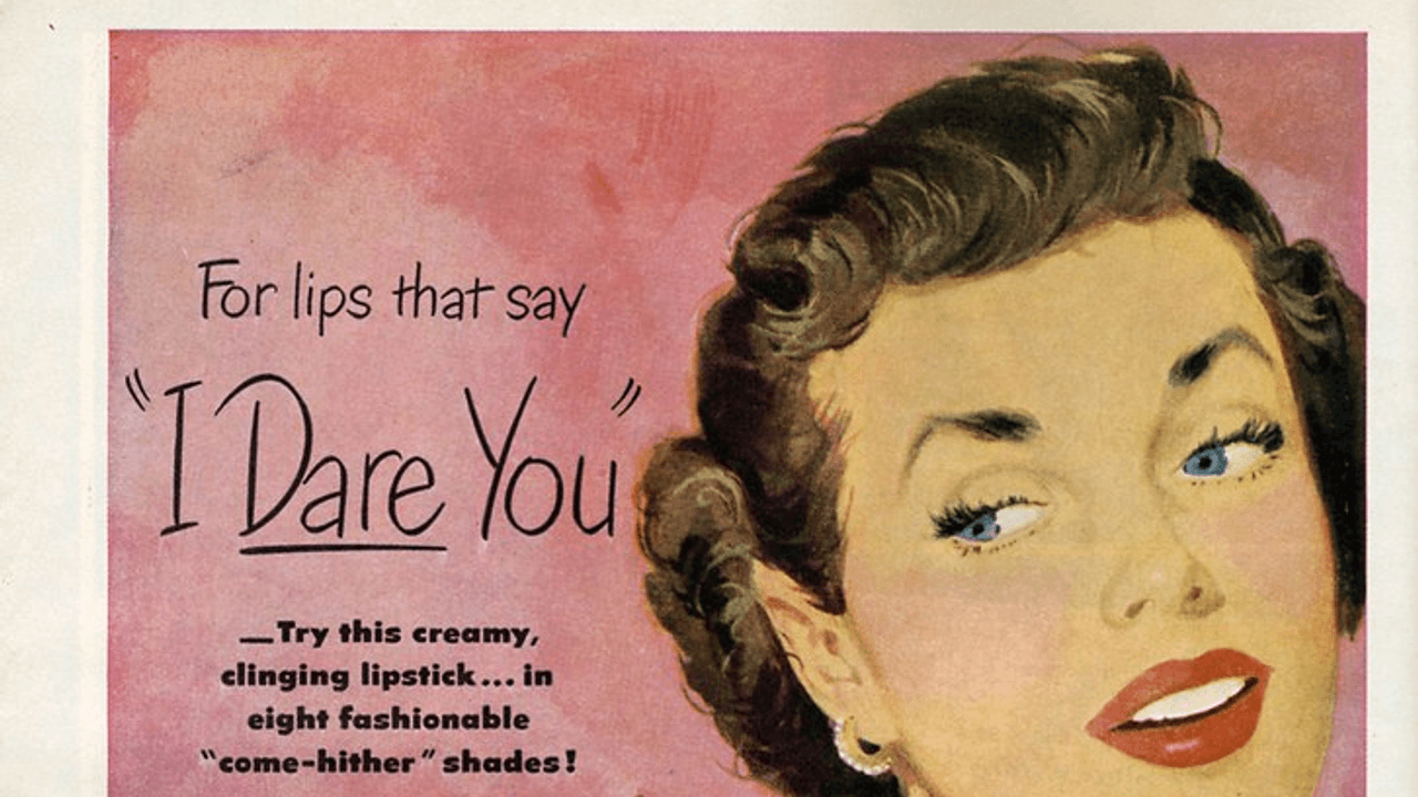 A woman in a dressing room applying lipstick at a vanity mirror in a scene inspired by retro lipstick ads, with warm lighting and a close-up on the tube and reflected face.